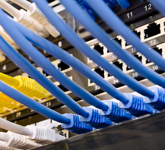 Data center, network panel, switch and connected cables. Close up shot, selective focus, networking technologies background.